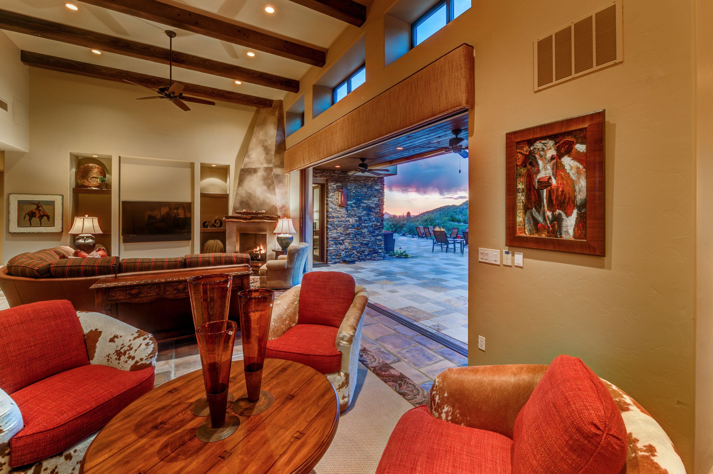 Game room with a billiard table, red upholstered seating and desert views