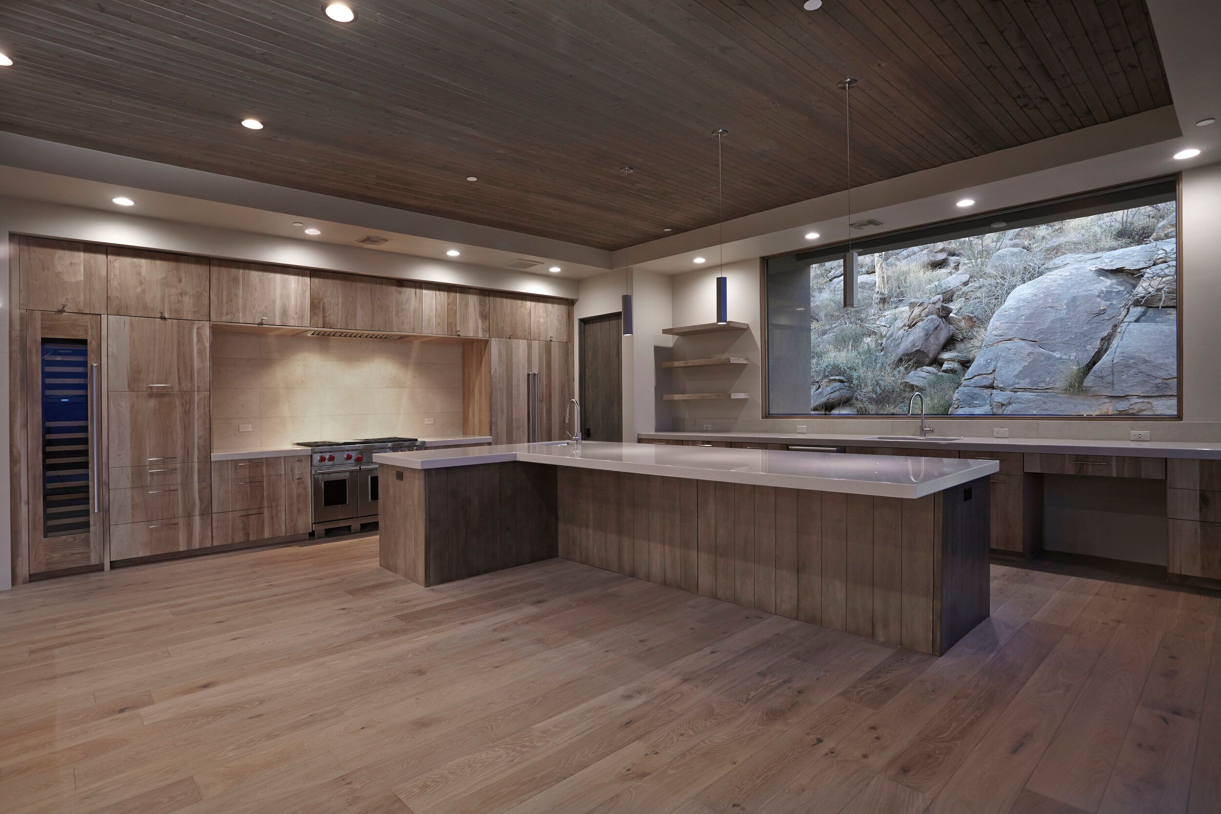 Kitchen with full-height rift oak cabinetry, a professional range and long island