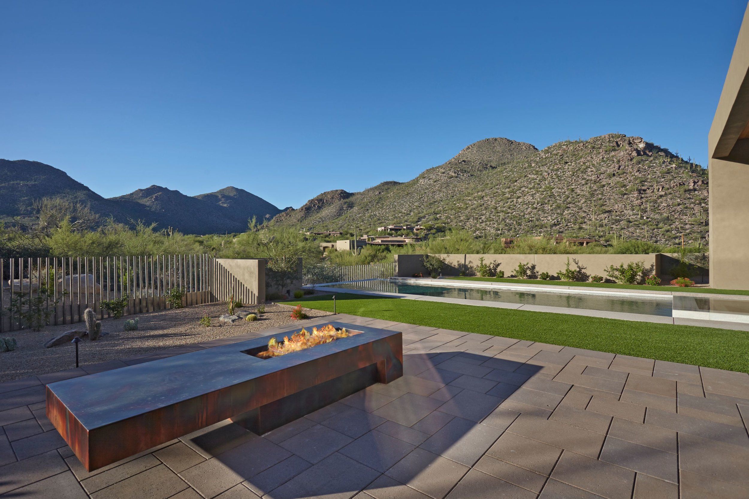 Corten steel fire feature on the terrace with mountain views beyond