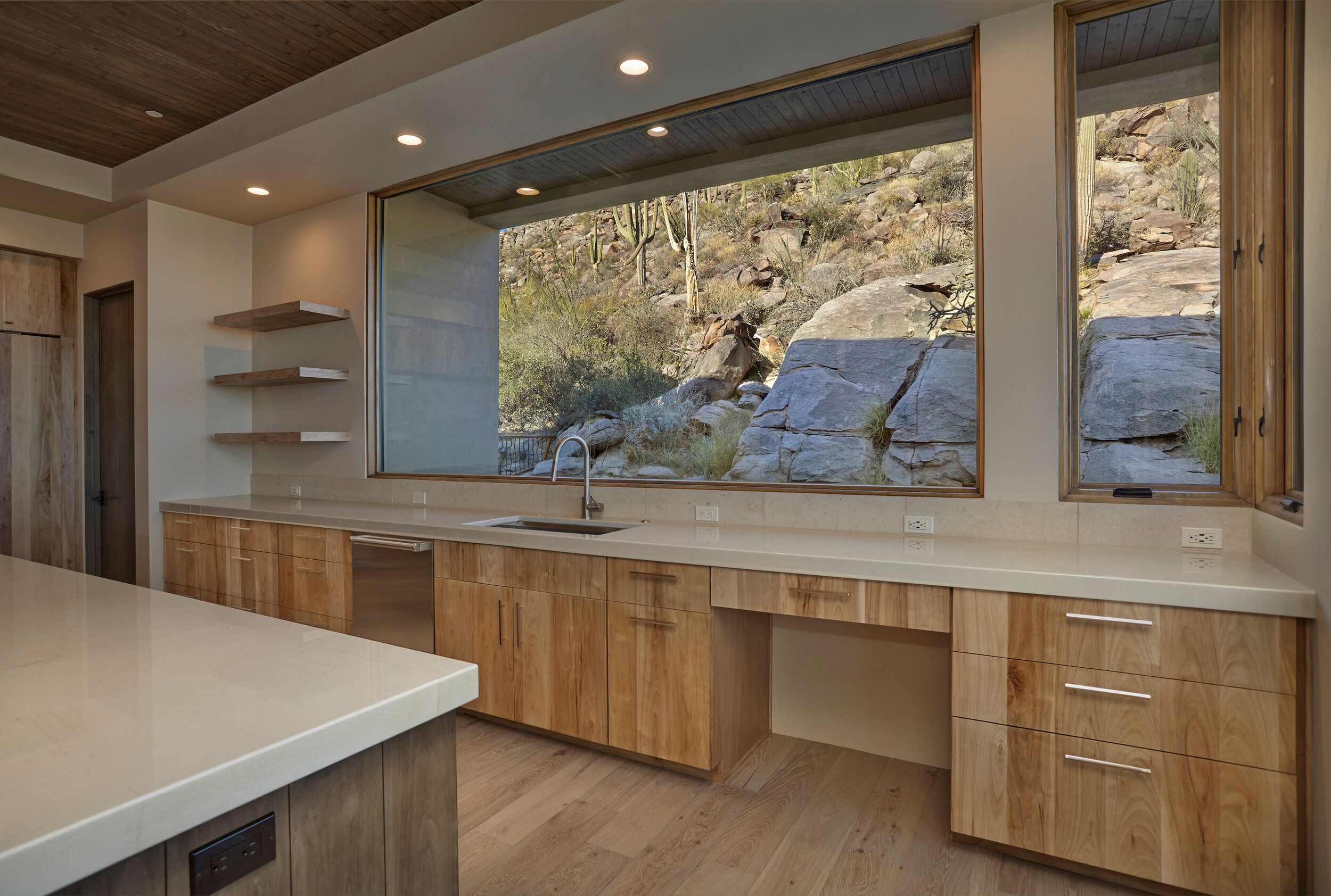 Kitchen counter and window wall looking directly onto granite boulders