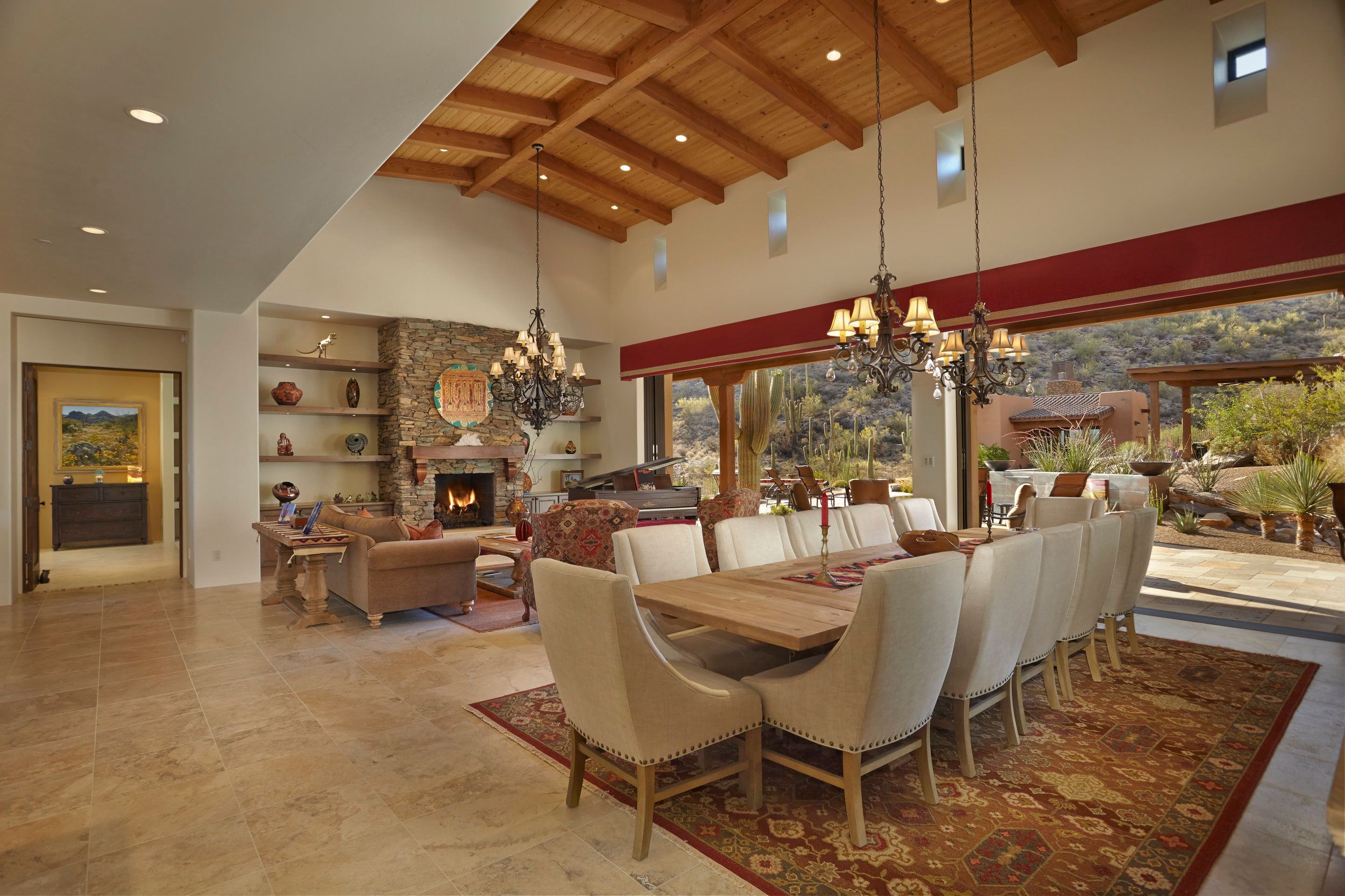 Open dining and living area with sliding glass doors onto the desert