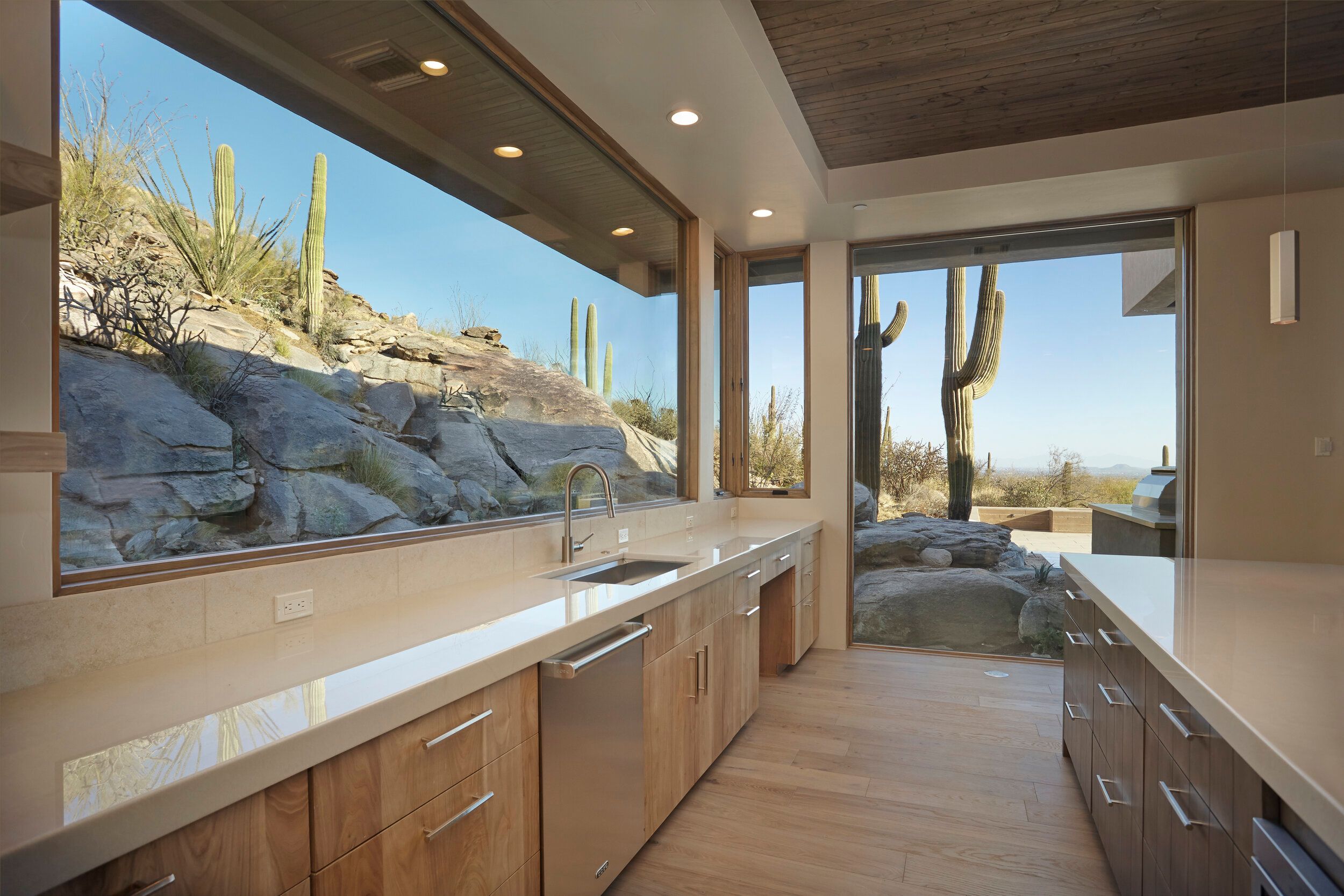 Galley kitchen with a ribbon window running the length of the counter