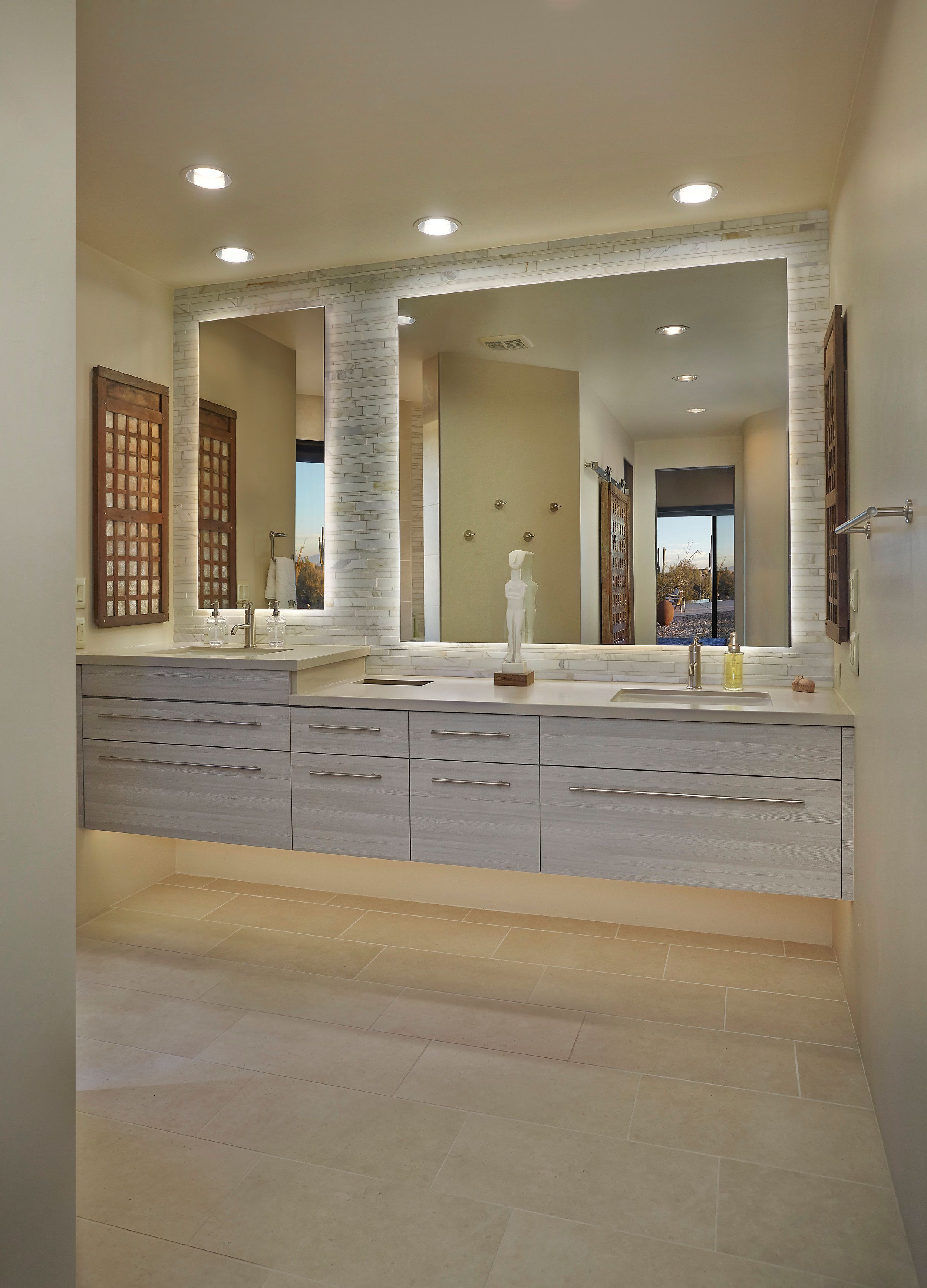 Primary bathroom with a floating vanity, wide mirror and carved screen panels