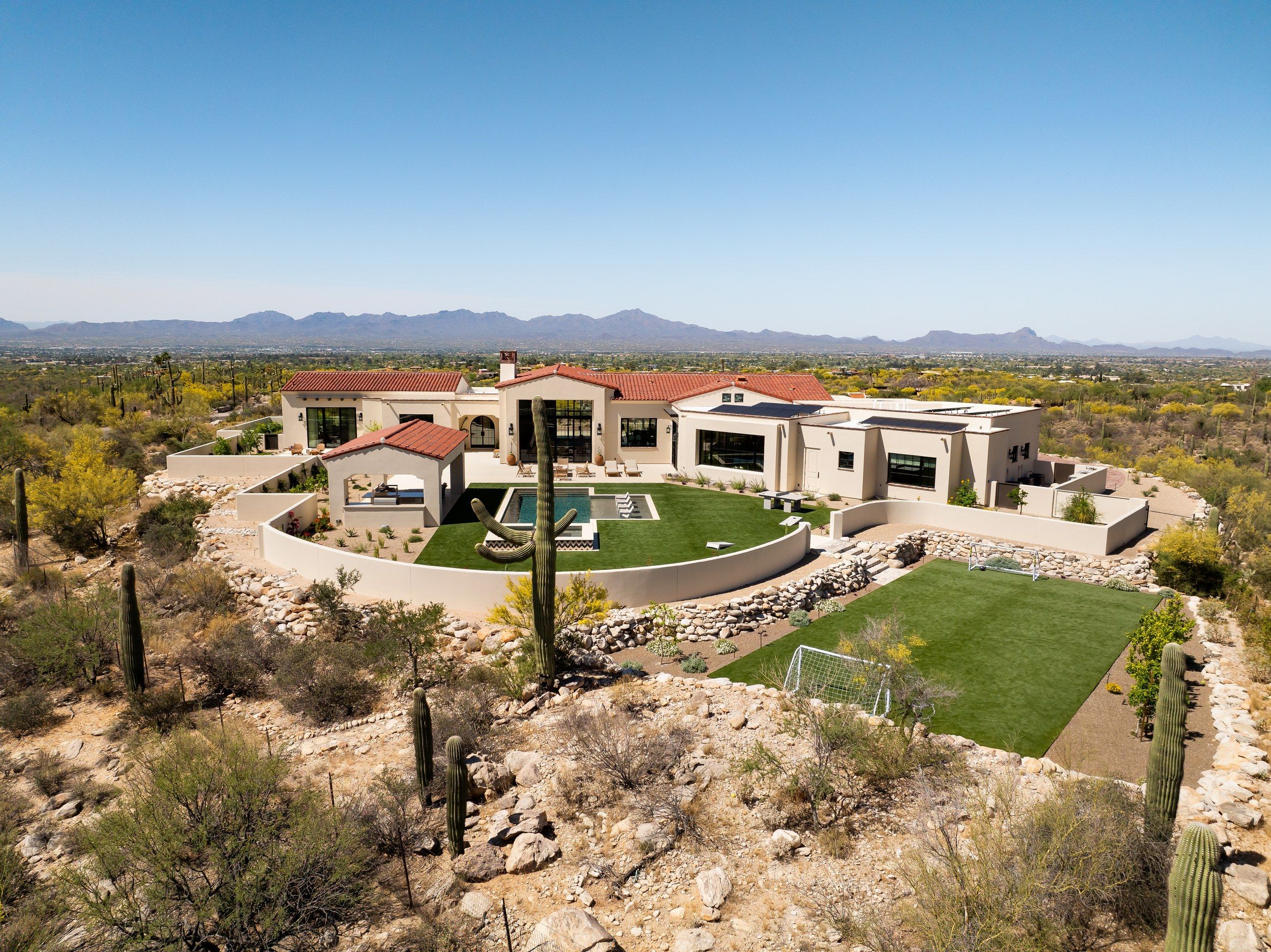 Aerial of the house, pool and lawn set in the Sonoran Desert