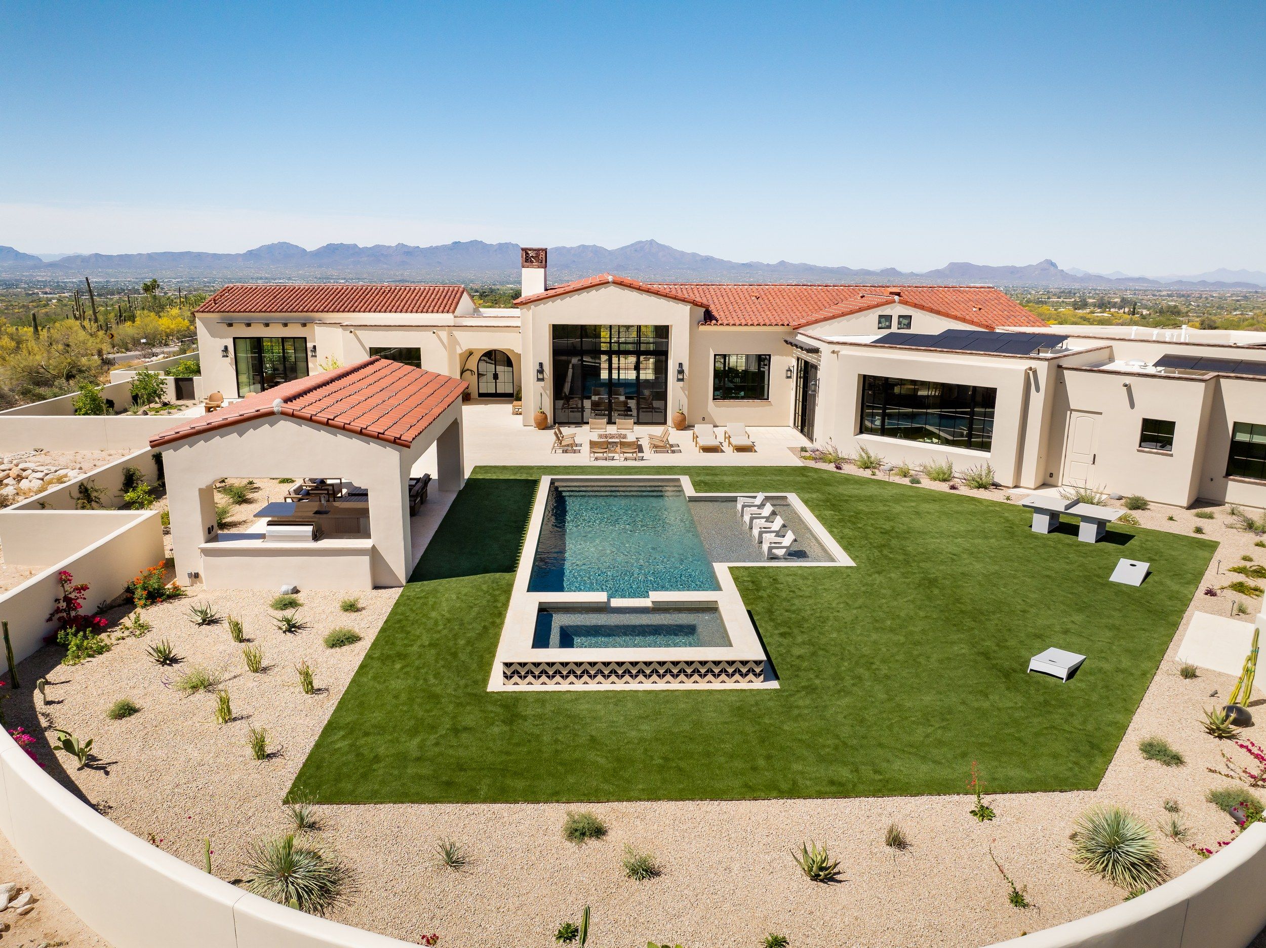 Aerial of the courtyard, pool and lawn enclosed by the house