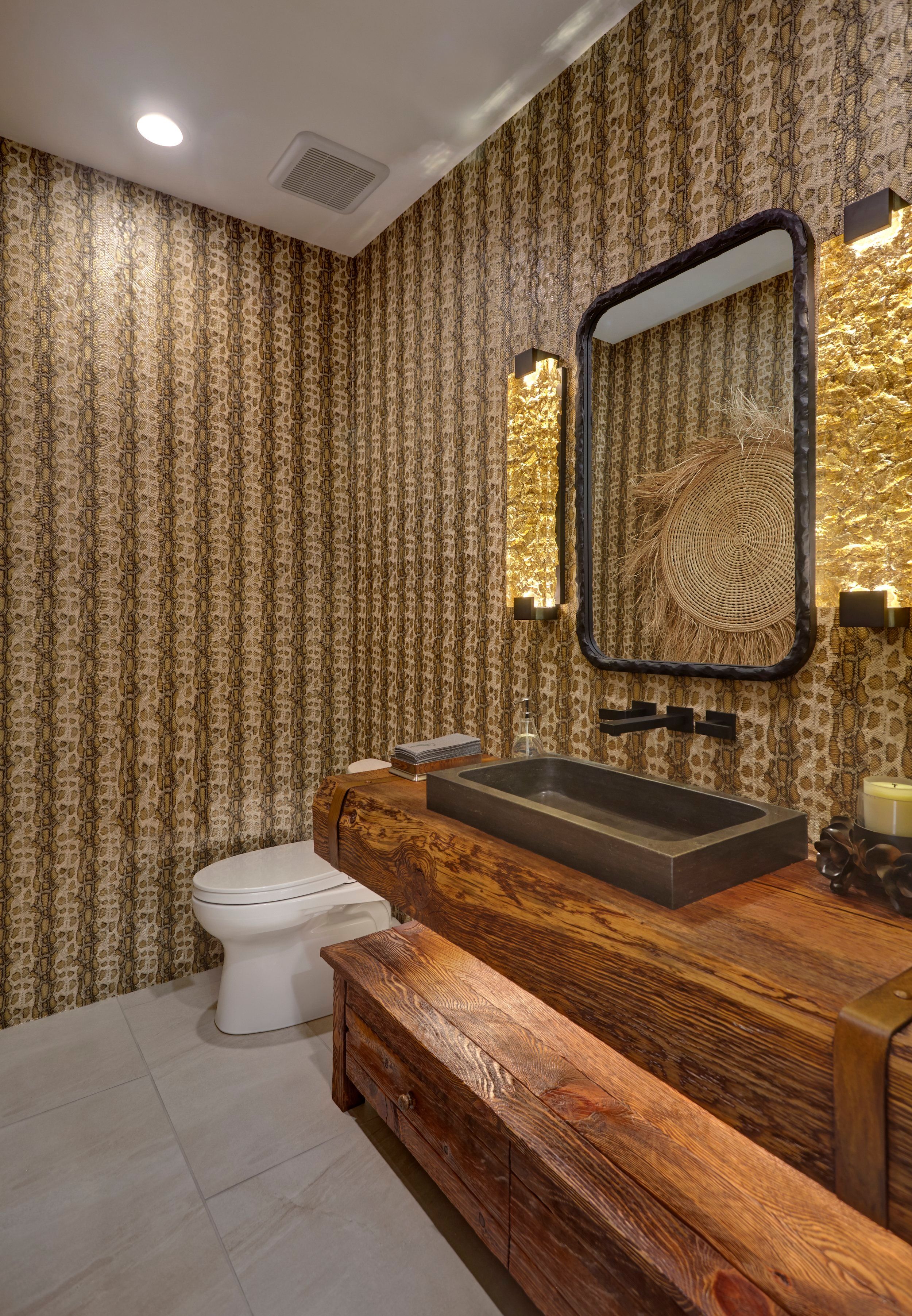 Powder room with patterned wallpaper, a live-edge timber counter and stone vessel sink