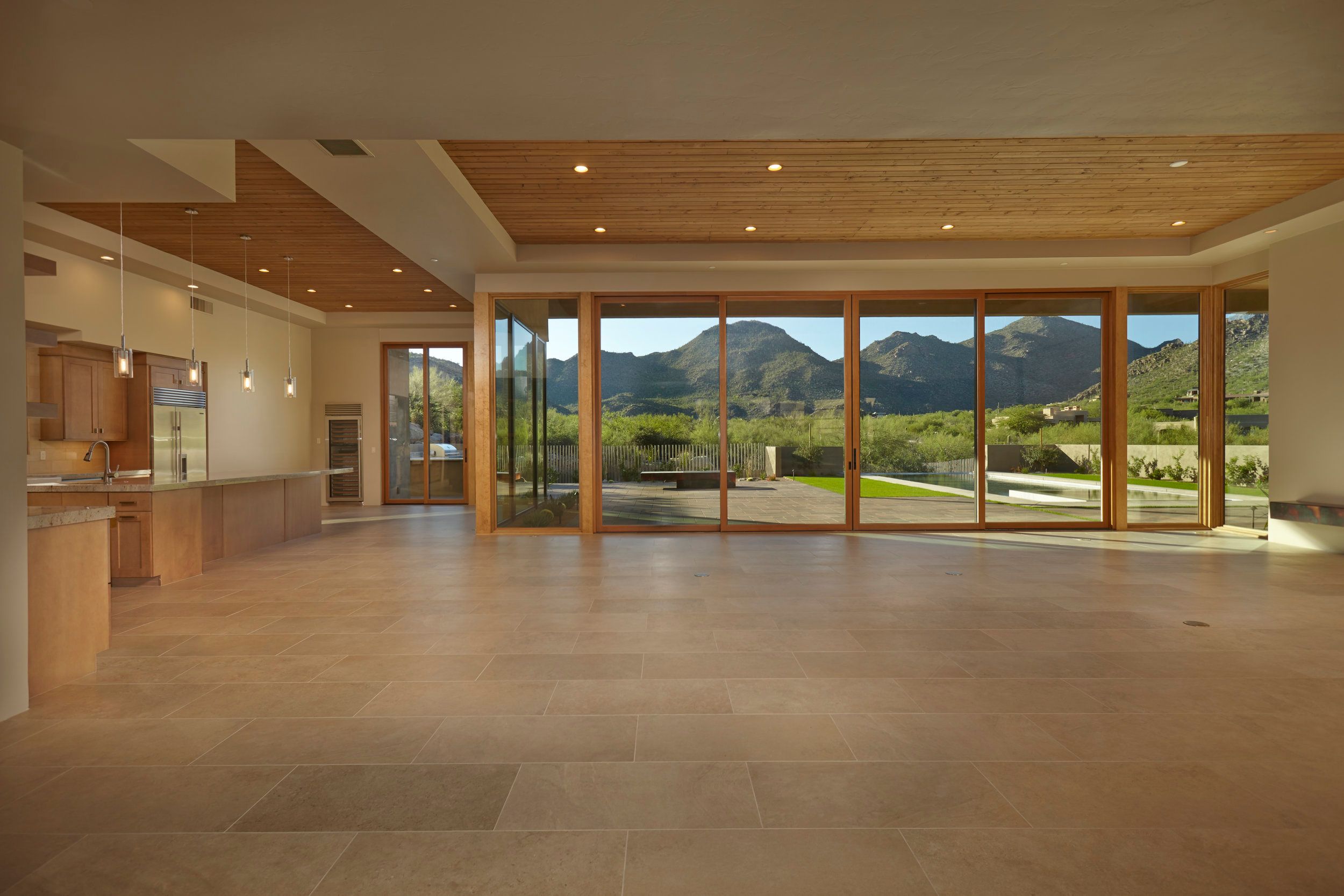 Open living space with pocketing glass doors framing the desert and mountains
