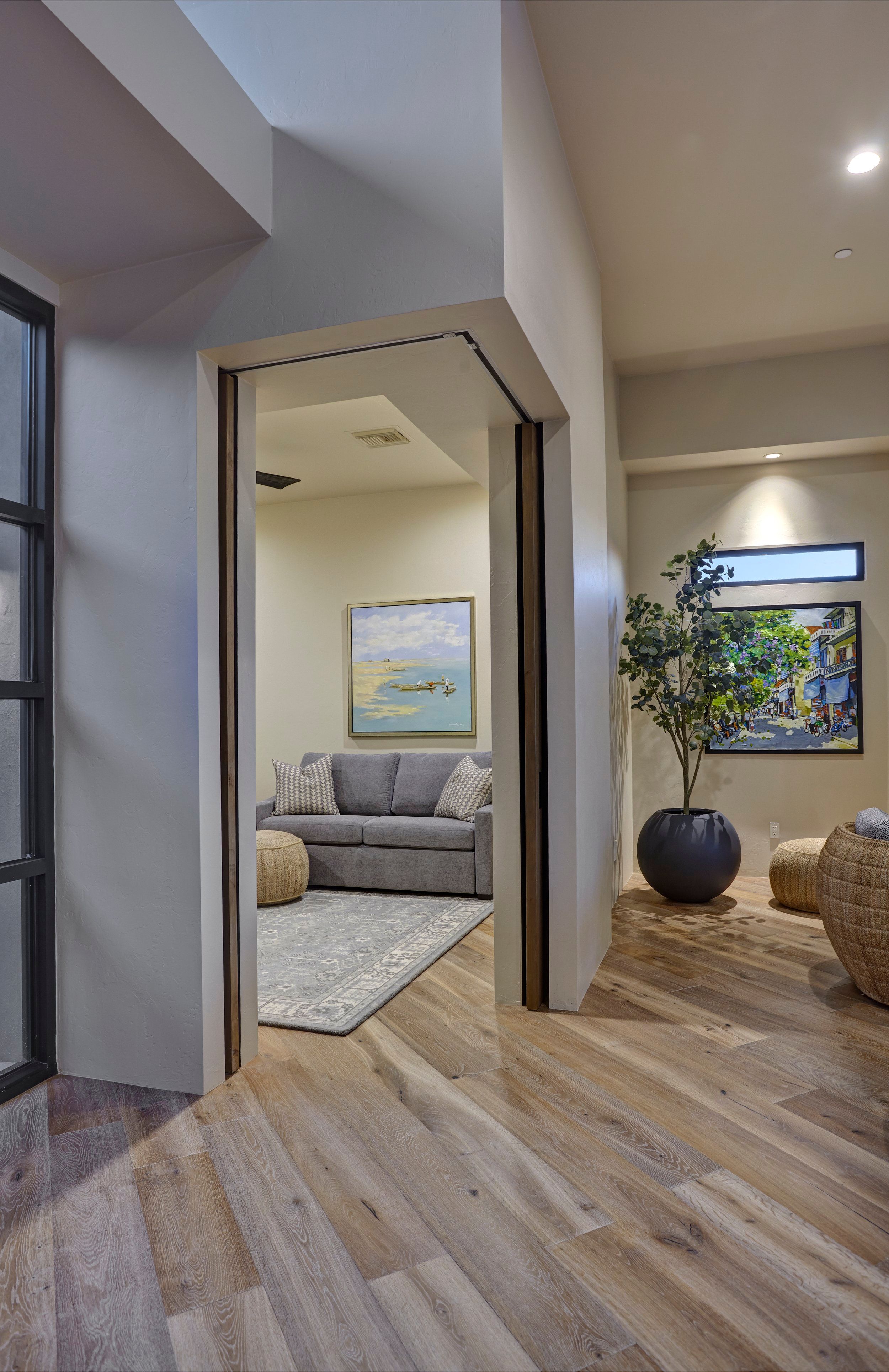 Pivot doors opening from the hallway into a sitting room