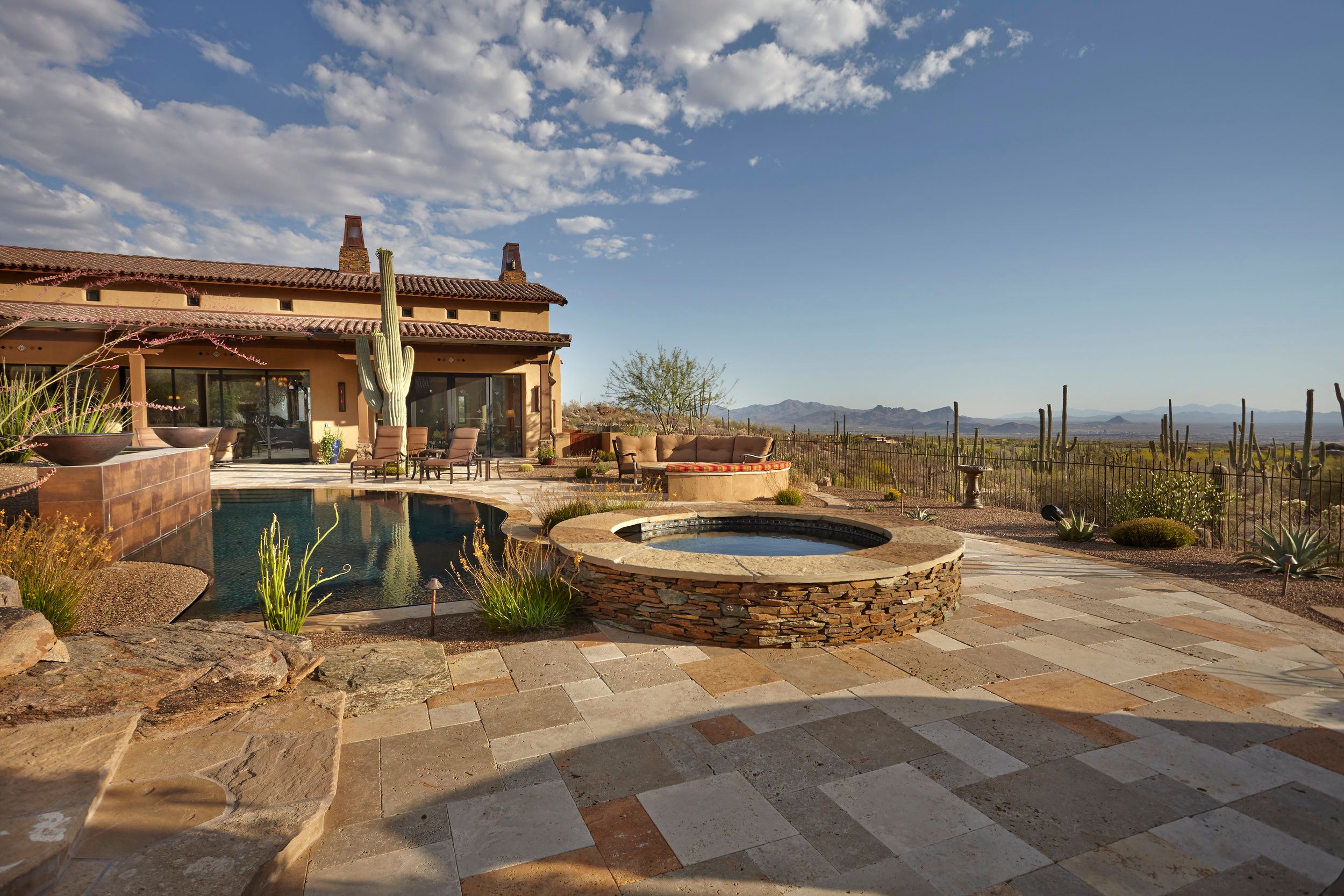 Negative-edge pool and circular spa looking out over the desert valley