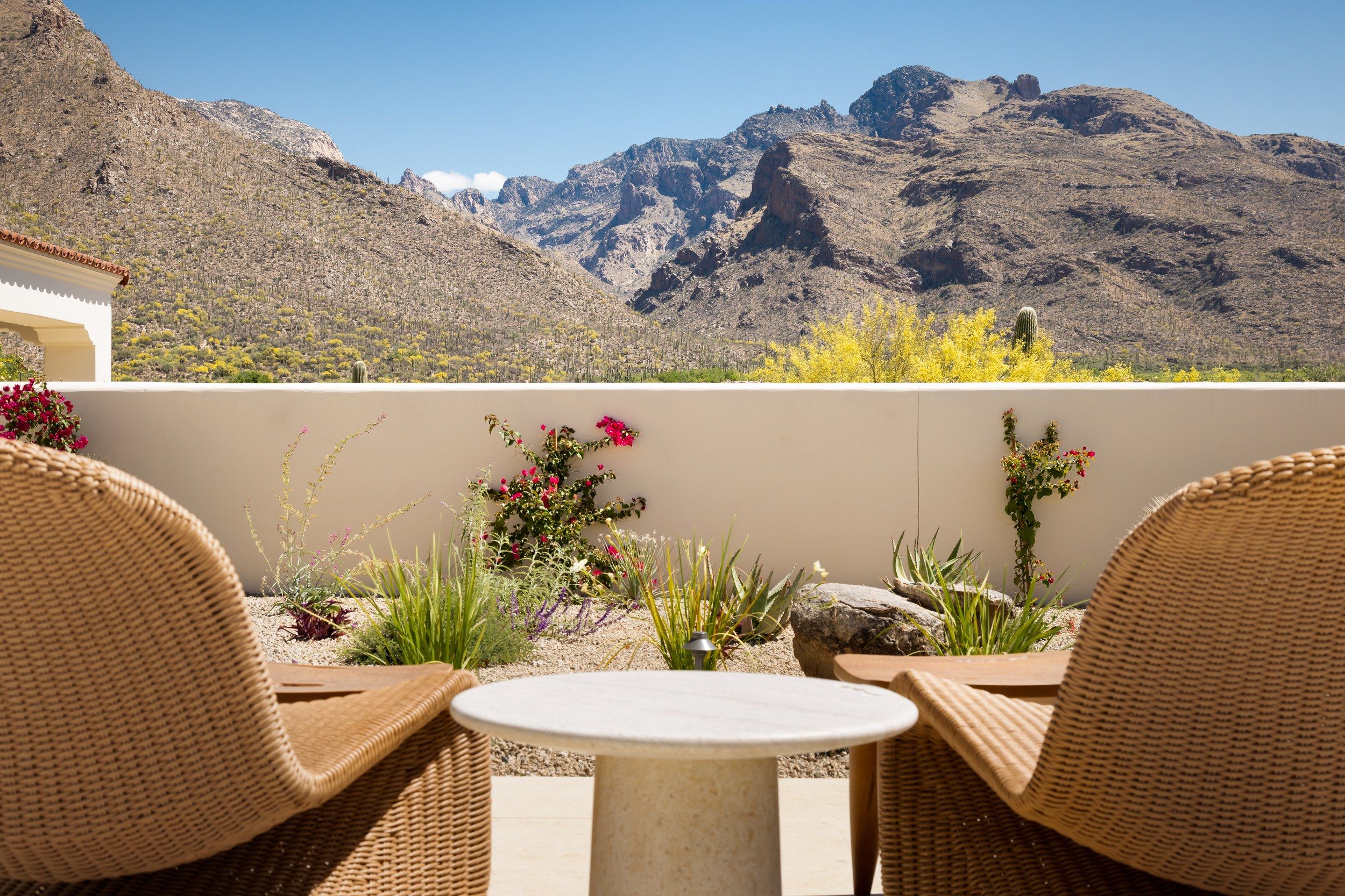 Walled patio seating with the Catalina Mountains rising beyond