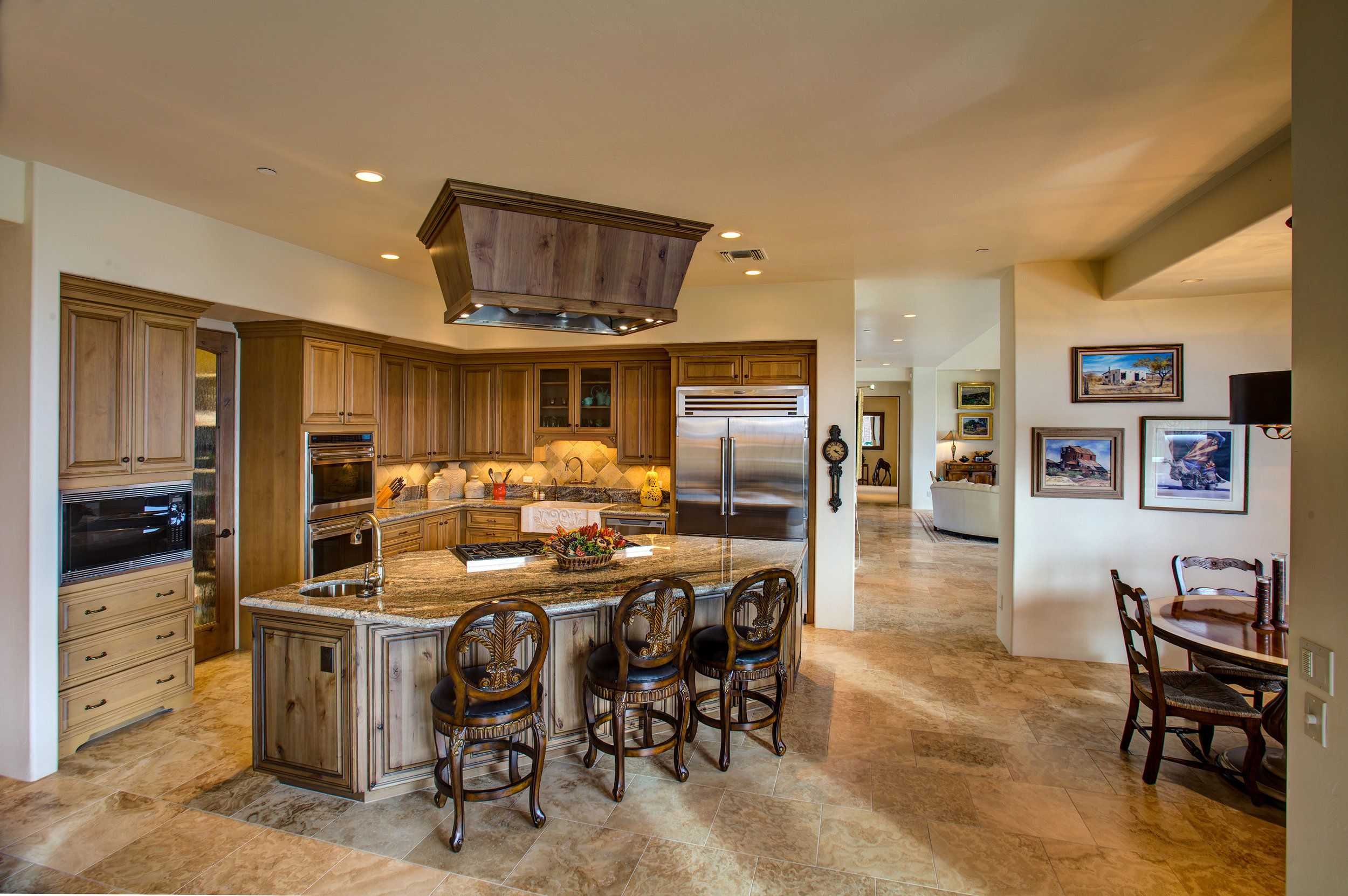 Kitchen with a large centre island, bar seating and stainless steel appliances