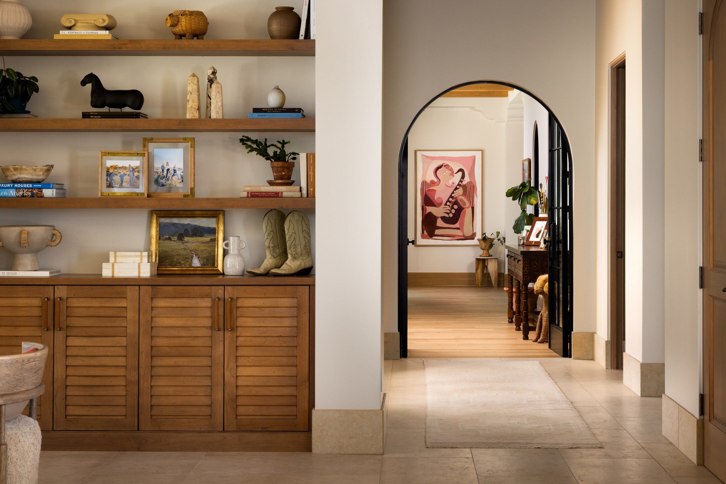Built-in shelving beside an arched doorway