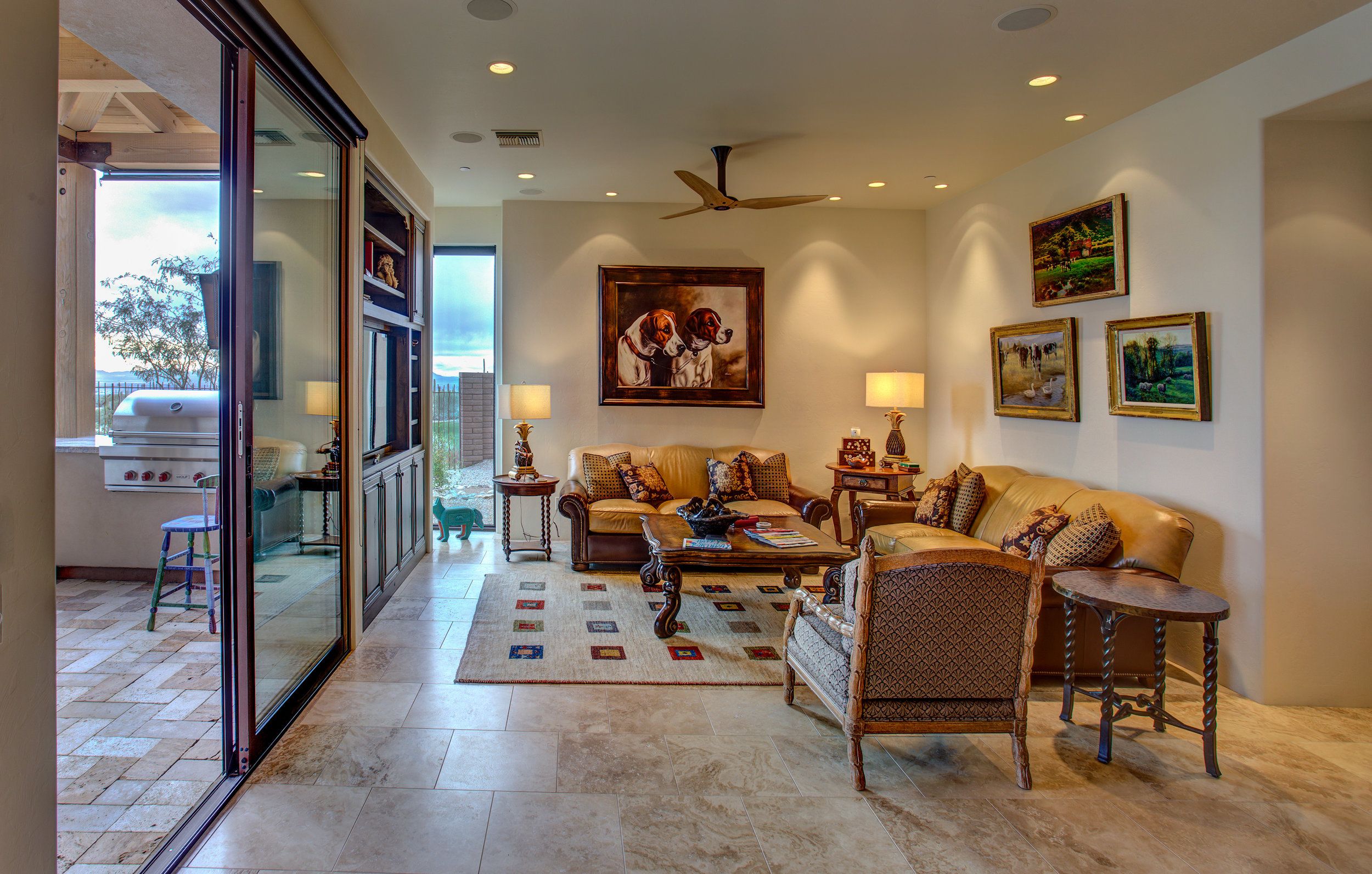 Family room with a ceiling fan, patterned area rug and sliding doors to the patio